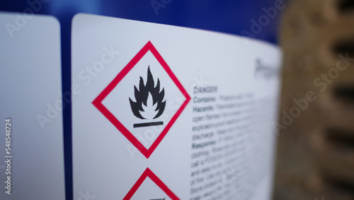 Flammable, acid, volatile, warning labels, mounted on hazardous chemical storage tanks in the warehouse of a chemical industrial factory plant. Waiting for delivery according to the user's order. photo