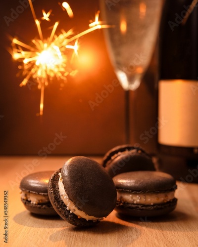 Vertical shot of brown macarons on a wooden surface - new year celebration dessert