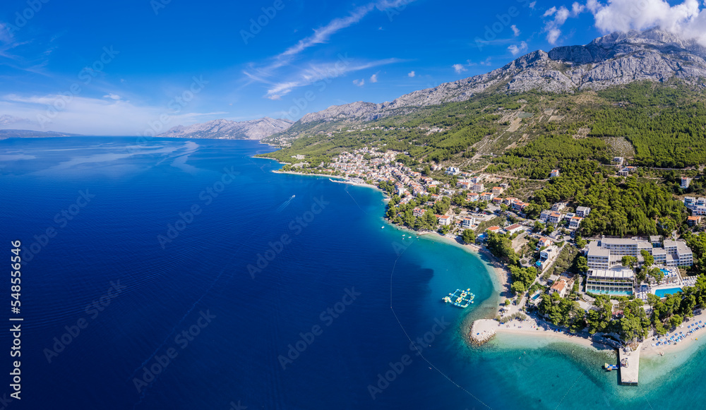 Beautiful Punta Rata beach in Brela, Croatia, aerial view. Adriatic Sea with amazing turquoise clean water and white sand on the beach.