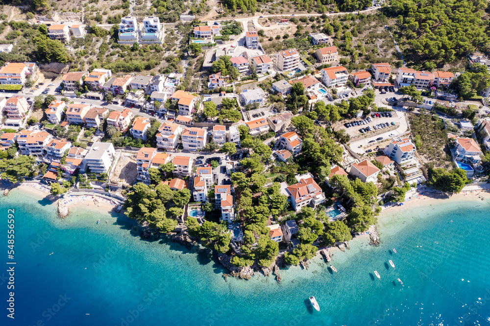 Croatia beach - panorama of Baska Voda town with harbor against mountains in Makarska riviera, Dalmatia, Croatia