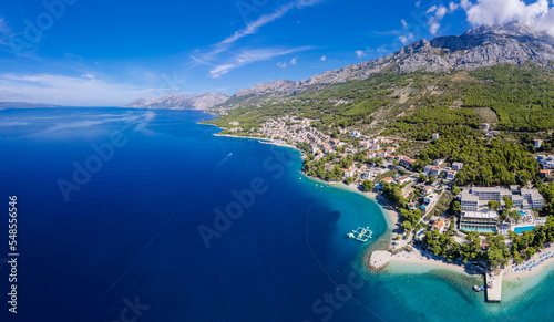 Beautiful Punta Rata beach in Brela, Croatia, aerial view. Adriatic Sea with amazing turquoise clean water and white sand on the beach.