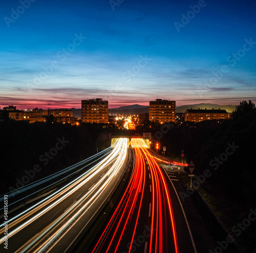 Rays of lights  in slow motion  of cars driving on the highway at night to enter and leave the city of Granollers  Barcelona.