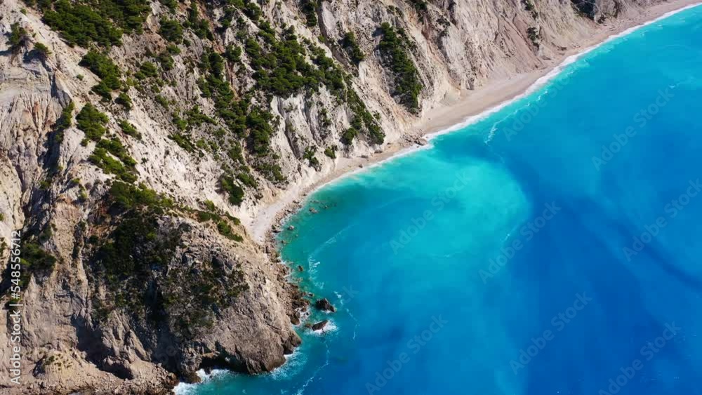 Aerial drone video of tropical paradise island covered in pine trees with turquoise crystal clear beach in paradise island destination resembling a blue lagoon Aerial drone video of tropical paradise island covered in pine trees with turquoise crystal clear beach in paradise island destination resembling a blue lagoon