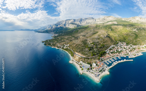 Beautiful Punta Rata beach in Podgora, Croatia, aerial view. Adriatic Sea with amazing turquoise clean water and white sand on the beach.