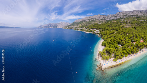 Fototapeta Naklejka Na Ścianę i Meble -  Croatia beach - panorama of Baska Voda town with harbor against mountains in Makarska riviera, Dalmatia, Croatia