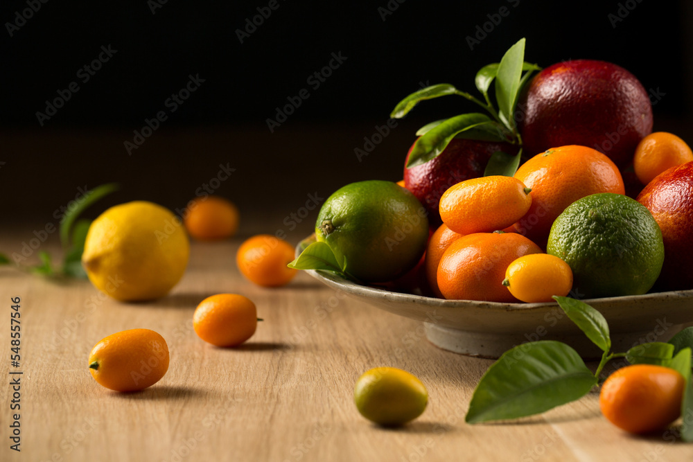 A variety of tropical citrus fruits on a ceramic plate