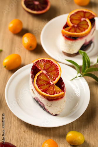 Panna cotta dessert with berry jelly and red orange