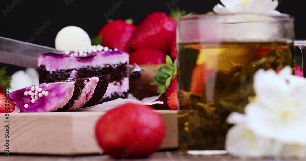 Cut purple cake with berry flavor, sweet dessert cake with red strawberries Cut purple cake with berry flavor, sweet dessert cake with red strawberries