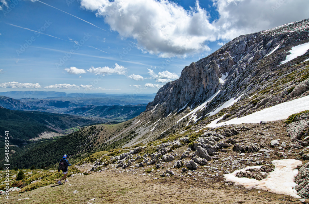 Man descending a beautiful snowy mountain landscape