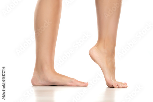 Side view of a beautifully cared female feet on a white background.