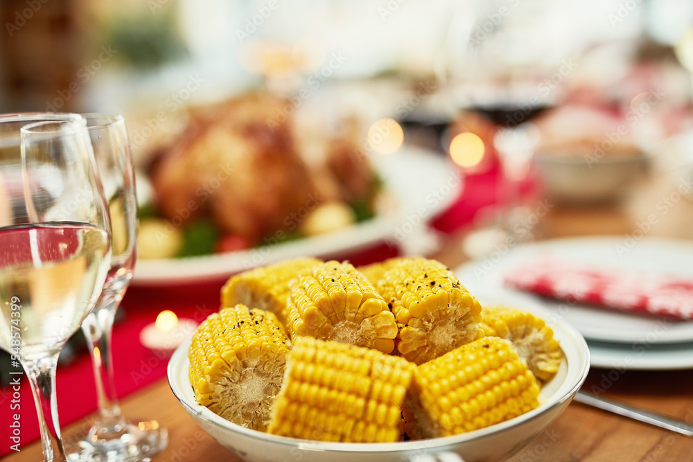 Corn, healthy and lunch on a table for a celebration, Christmas and nutrition in a house. Food, holiday and dinner in the dining room to celebrate Thanksgiving with a feast and vegetables at home