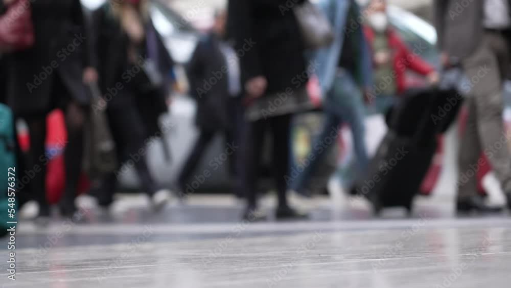 Passengers feet on train platform. Crowd of people traveling carrying bags. Low angle of legs in transit Passengers feet on train platform. Crowd of people traveling carrying bags. Low angle of legs in transit