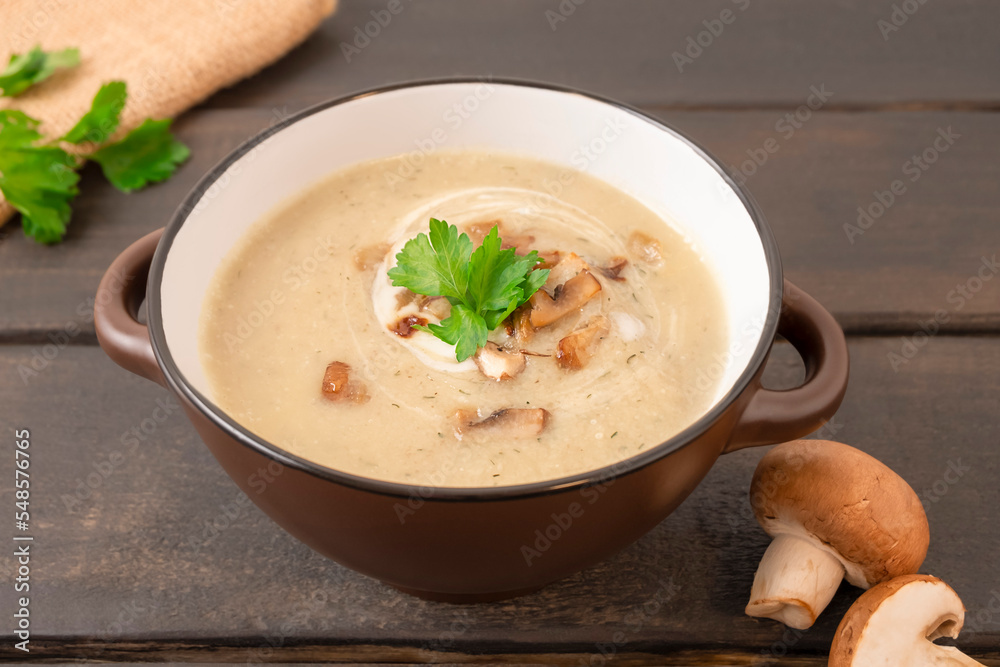 Mushroom cream soup on wooden background Mushroom cream soup on wooden background