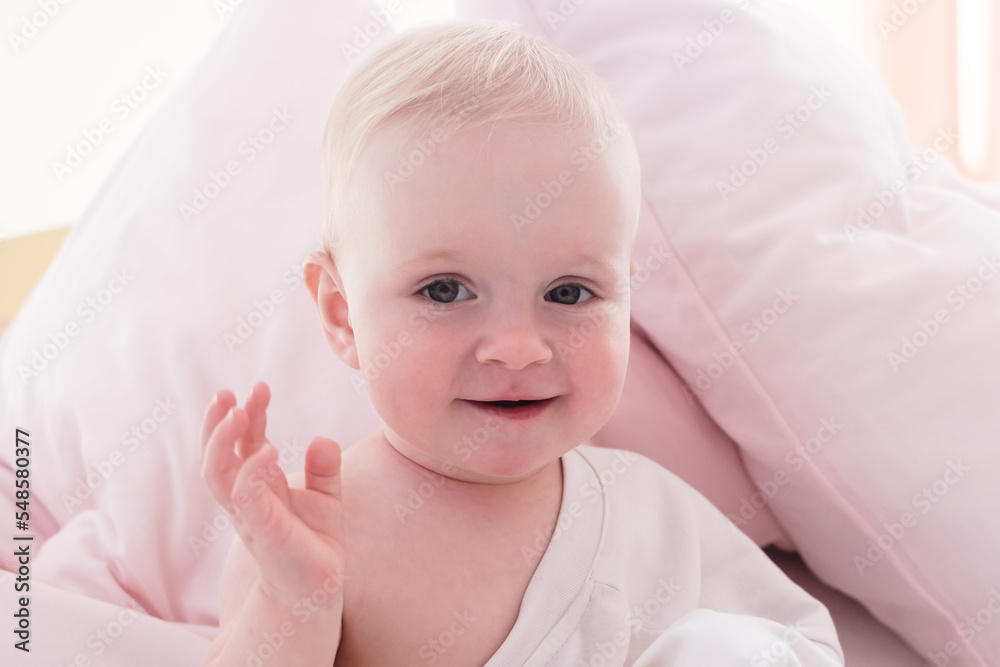 Cute caucasian baby looking at camera smiling. Positive human emotion Cute caucasian baby looking at camera smiling. Positive human emotion