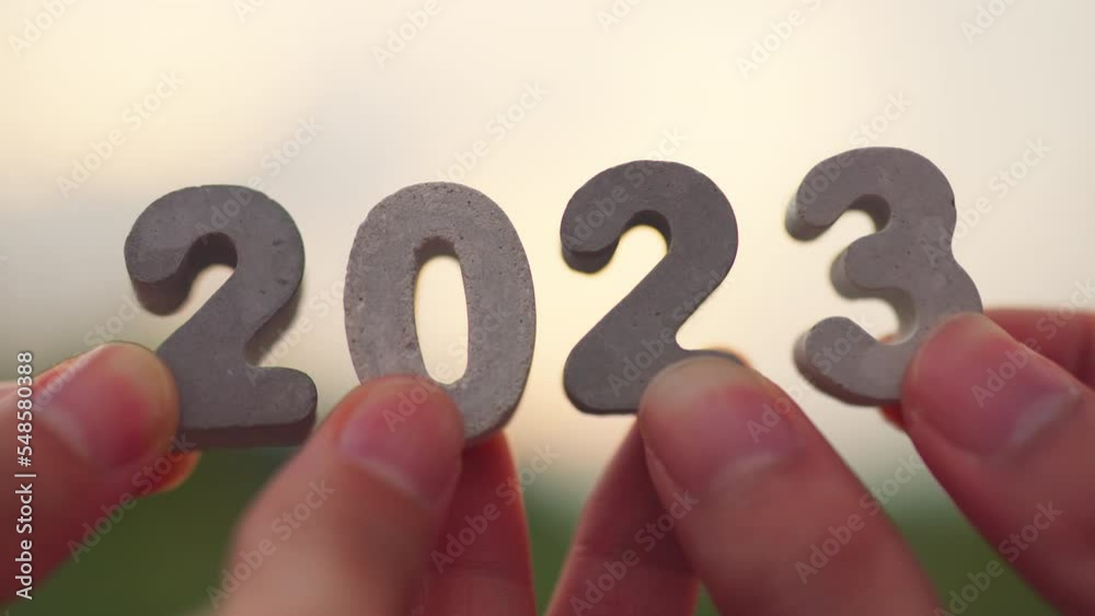 Happy New Year 2023, Hands of people's holding 2023 number in morning. Diverse friends congratulate new year.