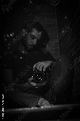 man in black room with camera