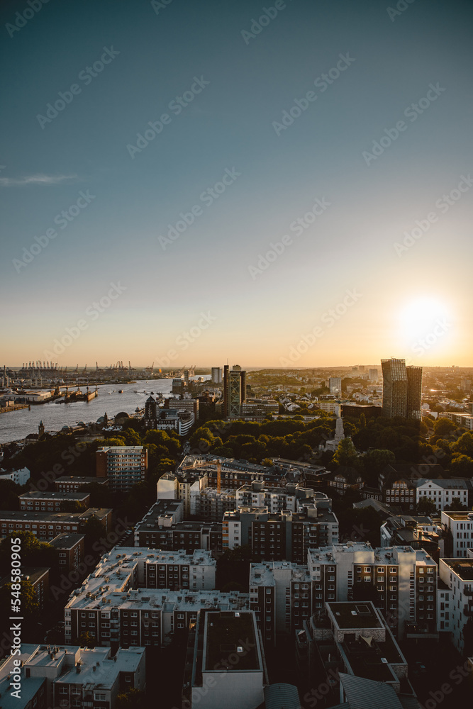 Top view of Hamburg Port at sunset. City Buildings during golden hour. Cityscape.