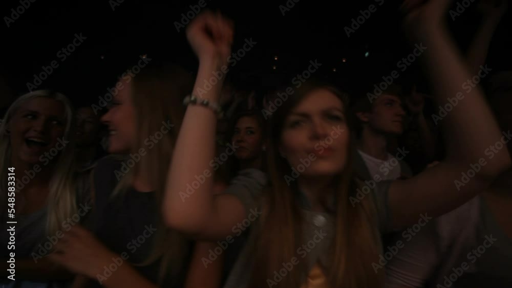 Party, concert and crowd at a disco dance event or music festival dancing with friends at a nightclub together. Freedom, rock or excited house fans in a crazy audience in a fun rave punk celebration