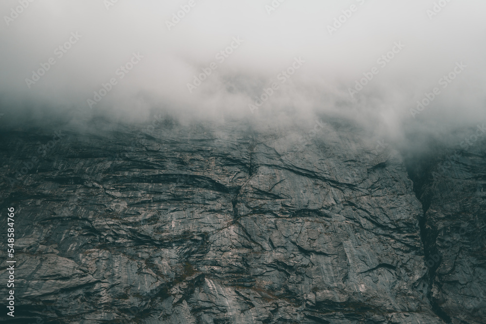 Fototapeta premium Beautiful mountain with some fog and clouds on it Background