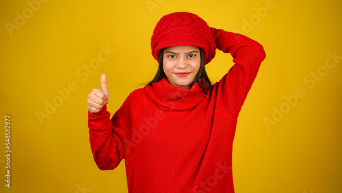 Young woman wearing winter clothes isolated over colour background, Beautiful girl wearing sweater © Arnav Pratap Singh