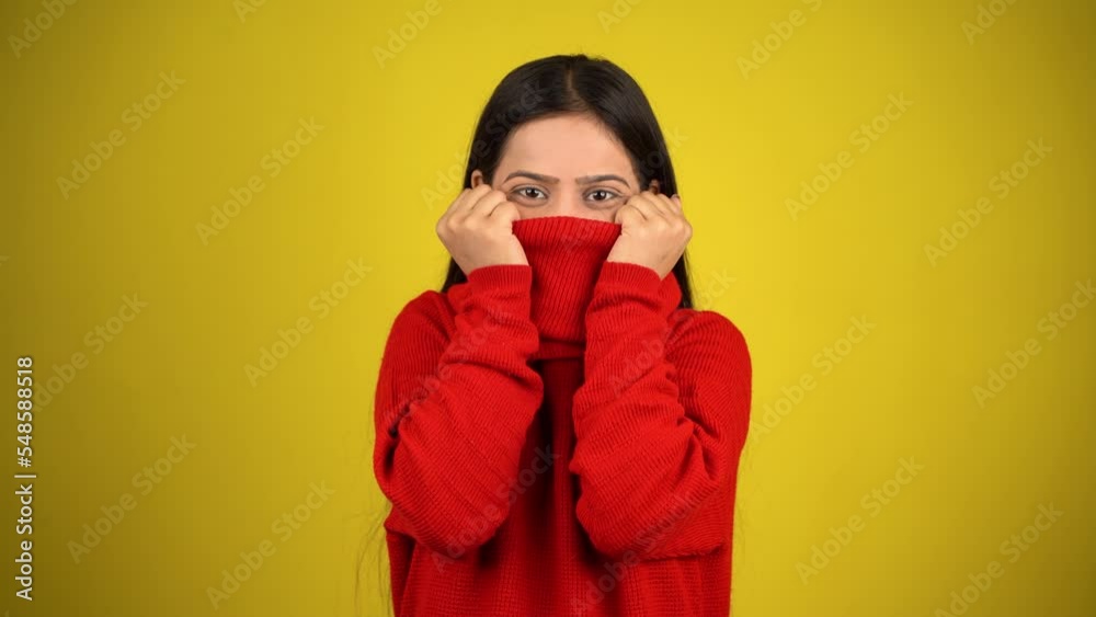 Young Woman feeling cold isolated over yellow background, Shivering due to cold, beautiful Asian Indian women Young Woman feeling cold isolated over yellow background, Shivering due to cold, beautiful Asian Indian women