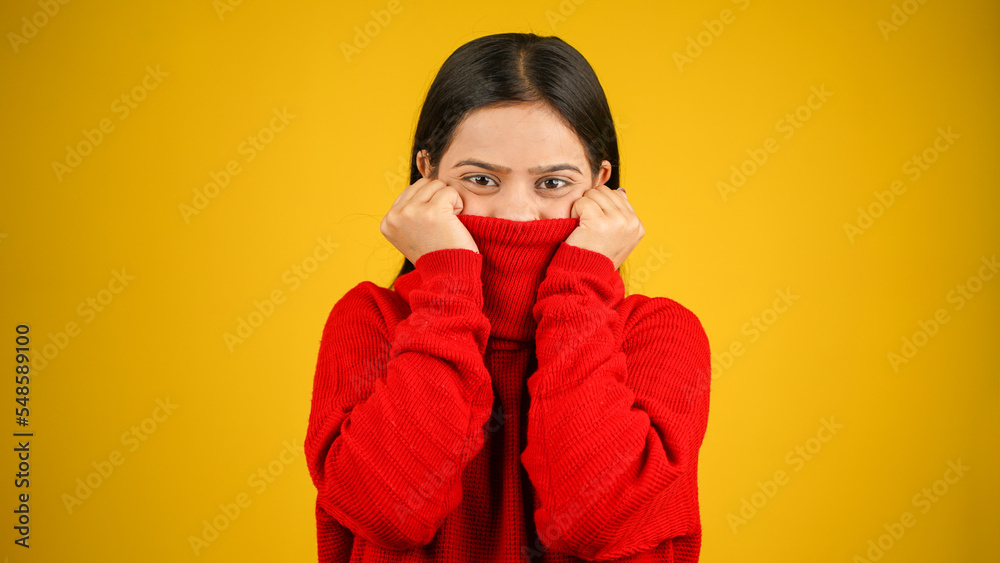 Young Woman feeling cold isolated over yellow background, Shivering due to cold, beautiful Asian Indian women Young Woman feeling cold isolated over yellow background, Shivering due to cold, beautiful Asian Indian women
