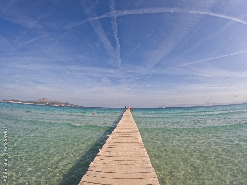 Beautiful panoramic view of Playa de Muro beach in Majorca with an amazing turquoise sea,. Concept of summer, travel, relax, hotel, holiday and enjoy	