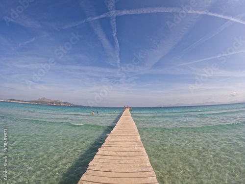 Fototapeta Naklejka Na Ścianę i Meble -   Beautiful panoramic view of Playa de Muro beach in Majorca with an amazing turquoise sea,. Concept of summer, travel, relax, hotel, holiday and enjoy	