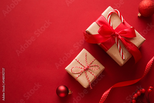 Christmas gifts, boxing day and traditional holiday presents flat lay, classic xmas gift boxes on red background, wrapped present with festive ornaments and decorations for holidays flatlay design photo