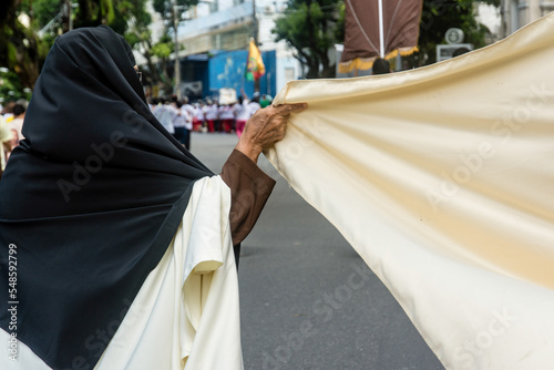 Catholic members hold flags during the Corpus Christ procession