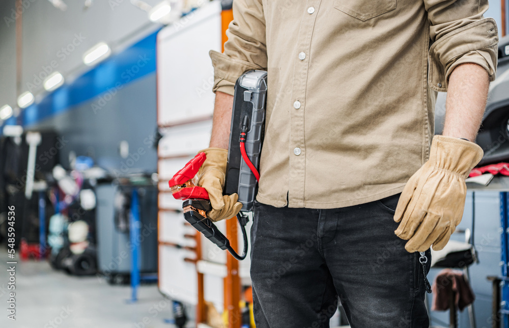 Professional Mechanic with Portable Car Jump Starter Professional Mechanic with Portable Car Jump Starter
