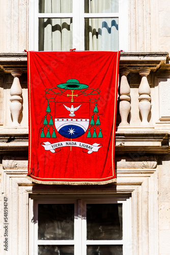 Red flag with the slogan faith hope love (vjera nada ljubav) on a building in Dubrovnik, Croatia. photo