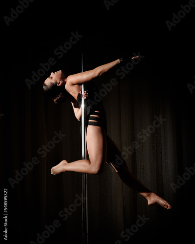 Fototapeta Naklejka Na Ścianę i Meble -  woman does pole dance sport at home
