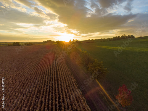 Aerial view of sunset behind a field in the countryside