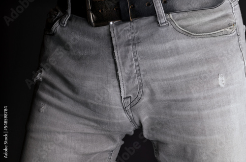 Male, lower body in tight grey jeans with black leather belt