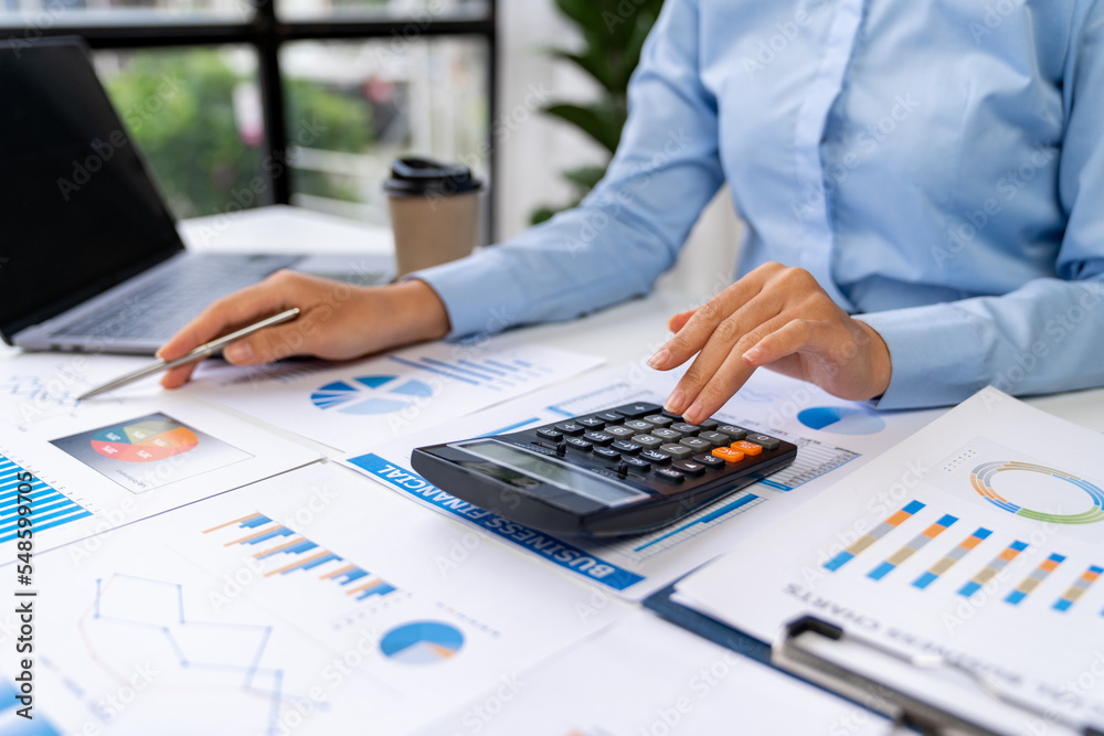 Asian business ideas are thinking and calculating with a calculator. front view of hand pointing to business data chart to calculate analysis Company financial processing. Asian business ideas are thinking and calculating with a calculator. front view of hand pointing to business data chart to calculate analysis Company financial processing.