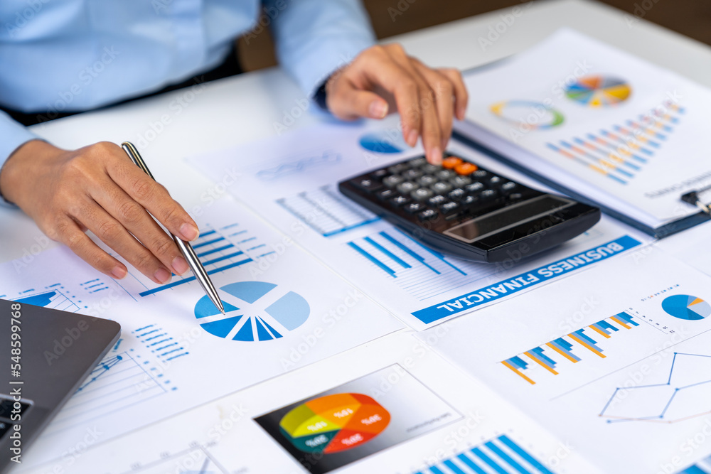 Asian business ideas are thinking and calculating with a calculator. front view of hand pointing to business data chart to calculate analysis Company financial processing. Asian business ideas are thinking and calculating with a calculator. front view of hand pointing to business data chart to calculate analysis Company financial processing.
