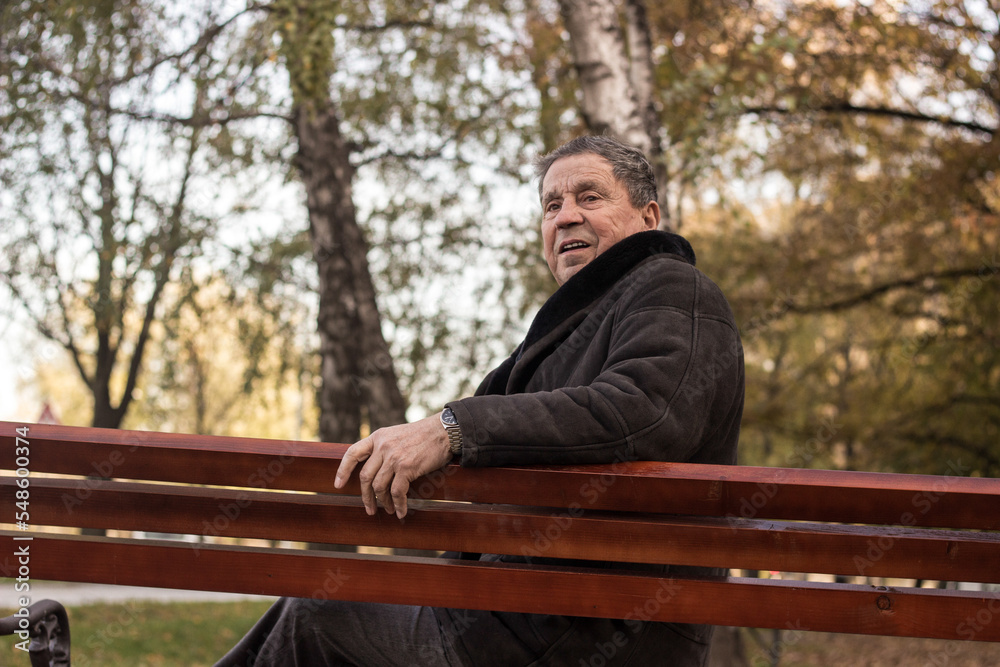 Fototapeta premium Lonely senior man sitting on bench