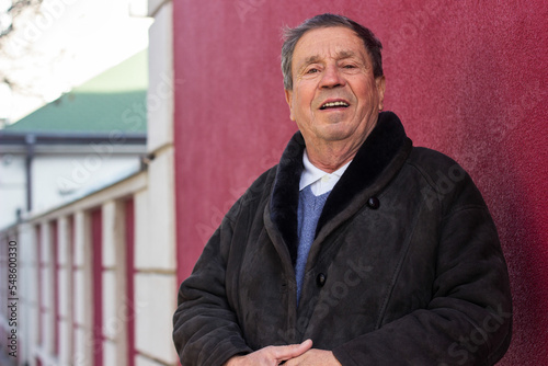 Wallpaper Mural Happy senior man standing against the red wall Torontodigital.ca