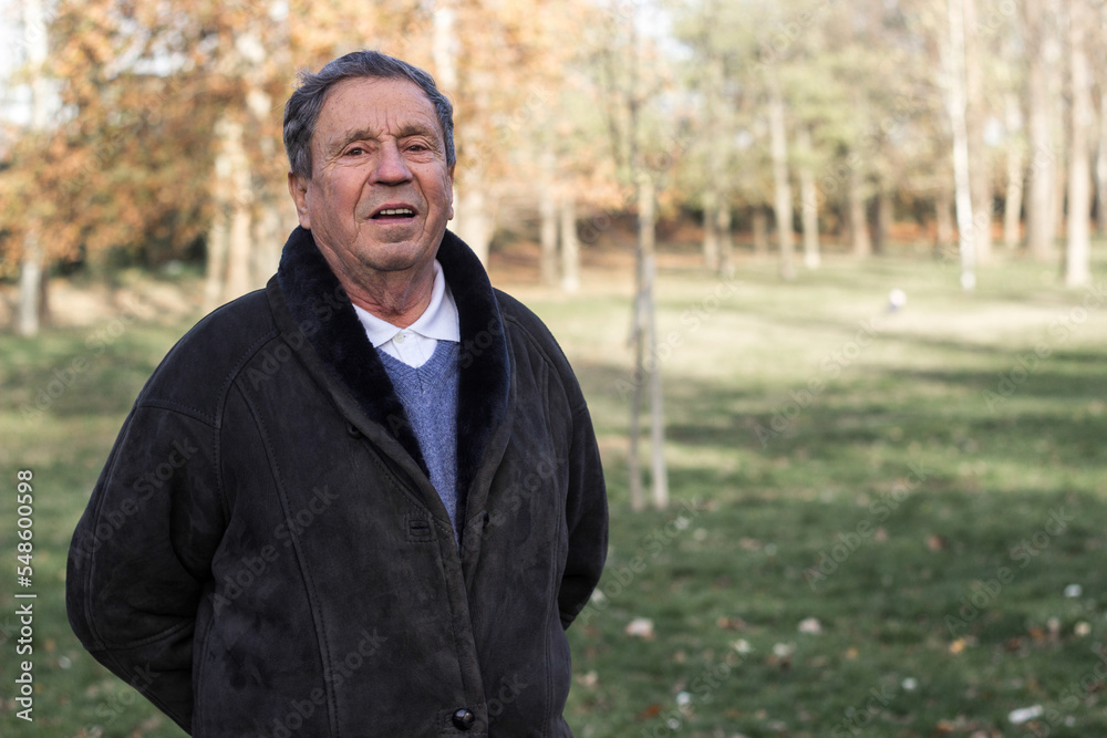 Pensive senior man walking at park