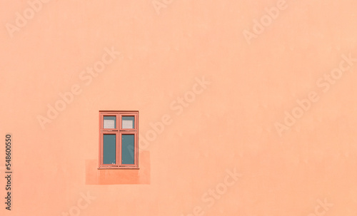 Window in a peach coloured wall. Minimal Aesthetic.