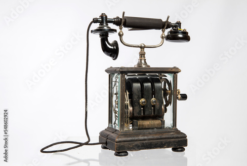 Old telephone isolated white background photo