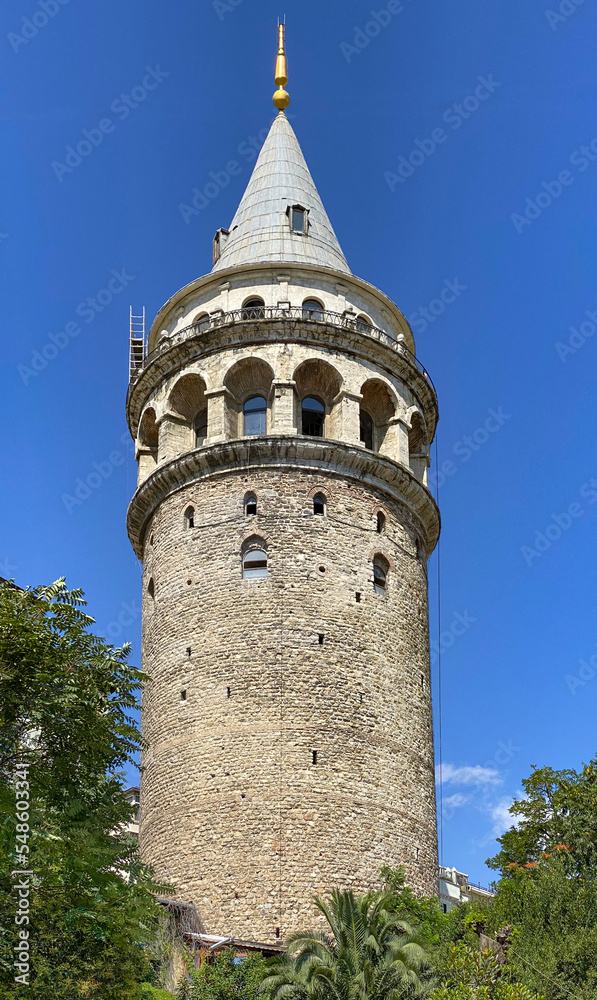 Aerial  shot of the Galata Tower in Istanbul, Turkey. Aerial view of landmark at golden hour with beautiful sunlight.