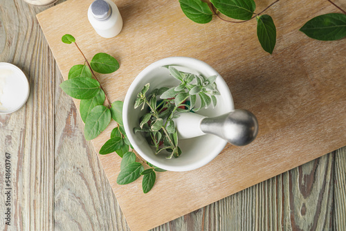 Mortar with herbs on light ...