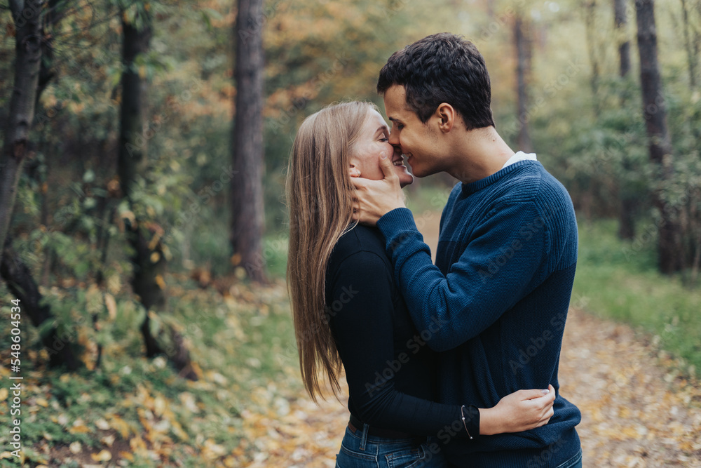 Romantic young couple kissing in a forest Romantic young couple kissing in a forest