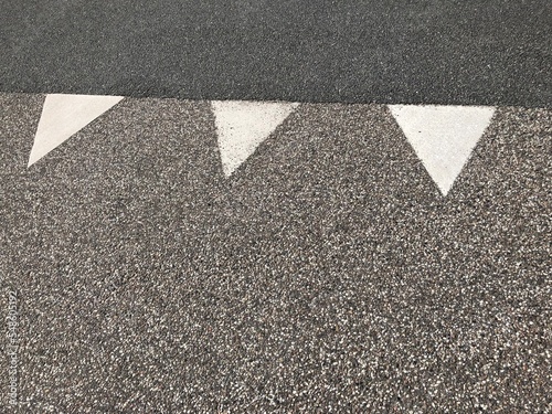 asphalt background with yield lines