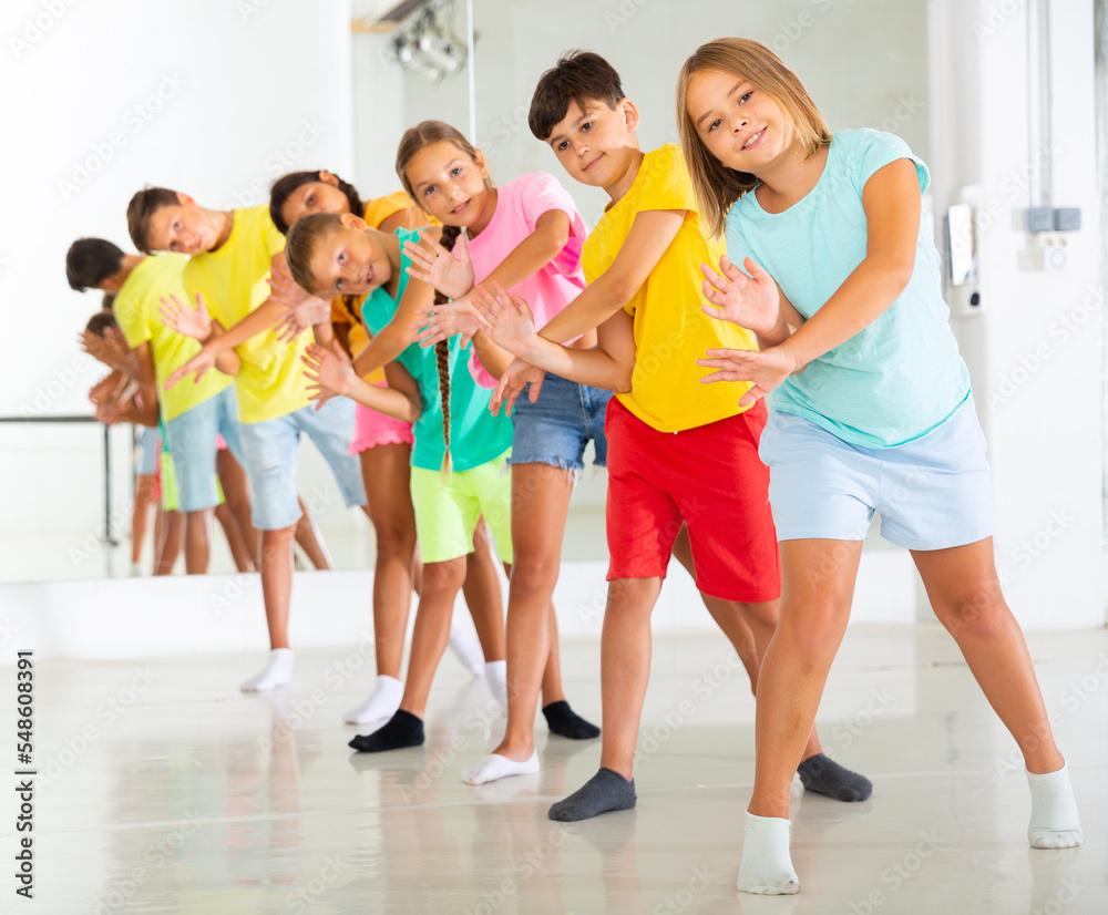 Boys and girls standing in row on their group dance classes.