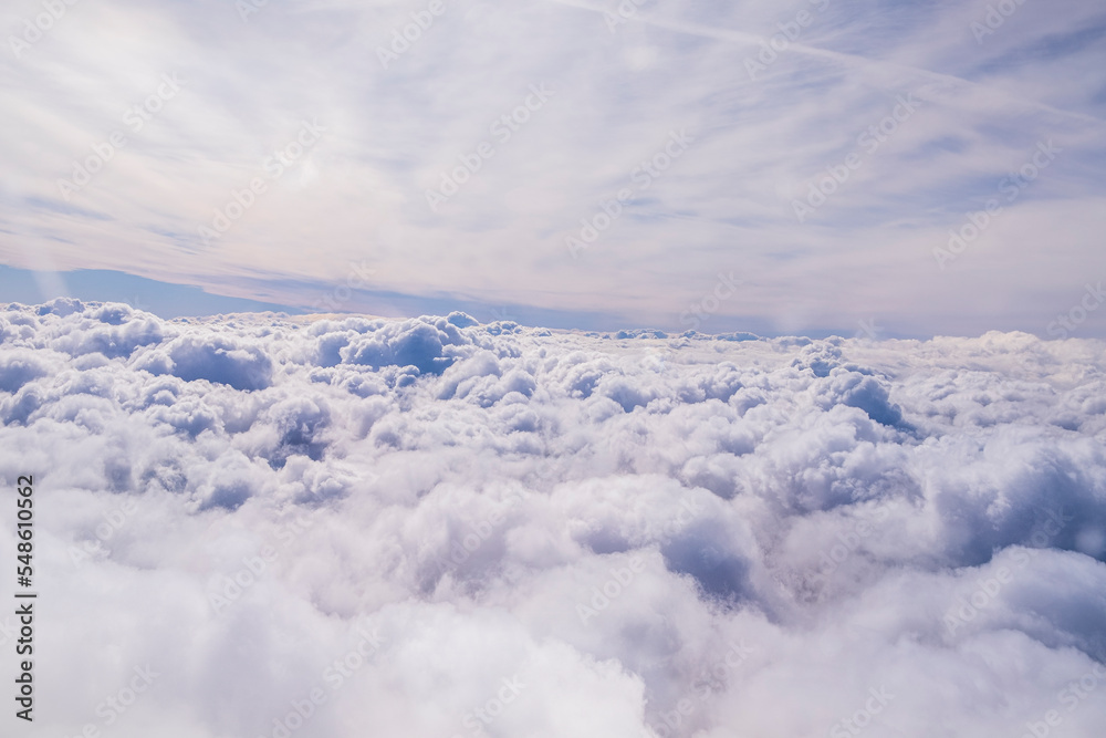 Blue sky and clouds background with copy space.. above the clouds. View from the sky to the clouds. Sunrise over the clouds. Sky and airplane ride.