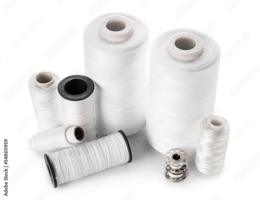 Different thread spools isolated on white background Different thread spools isolated on white background