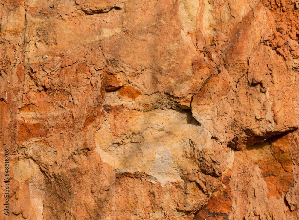 Sedimentary rocks with a high content of iron oxide. Red soil, loam. The texture of the soil.